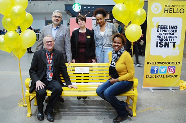 Clockwise from top: Sam Fiorella, Marketing professor and co-founder of the Lucas Fiorella Friendship Bench; Laurel Schollen, Vice-President Academic; Mental Health Intervention students Bilise Lome and Camille Nelson, and David Johnston, Director, Counselling and Accessibility Services, celebrate the Friendship Bench installation at Newnham Campus, December 2016. 